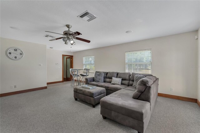 living room featuring ceiling fan and light colored carpet