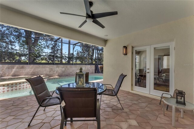 view of patio with ceiling fan, a fenced in pool, french doors, and glass enclosure