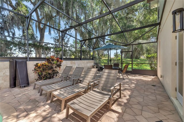 view of patio featuring a lanai