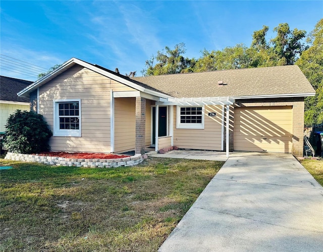 single story home featuring an attached garage, a shingled roof, concrete driveway, and a front yard