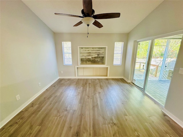 unfurnished living room featuring ceiling fan, lofted ceiling, and light hardwood / wood-style flooring