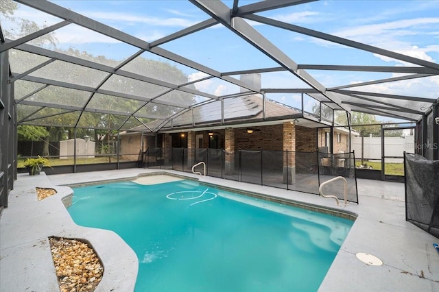 view of swimming pool featuring glass enclosure and a patio