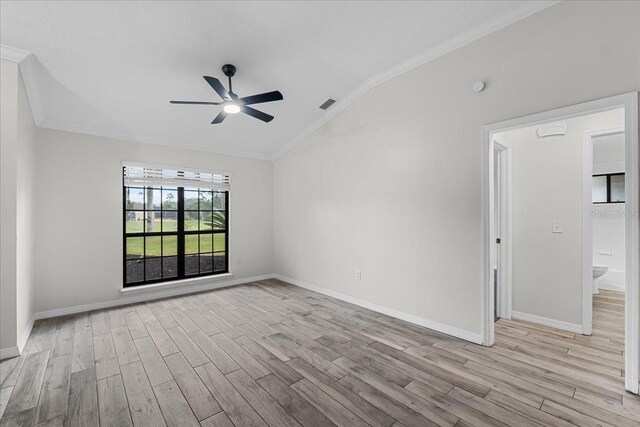 unfurnished room with lofted ceiling, ceiling fan, crown molding, and light hardwood / wood-style flooring