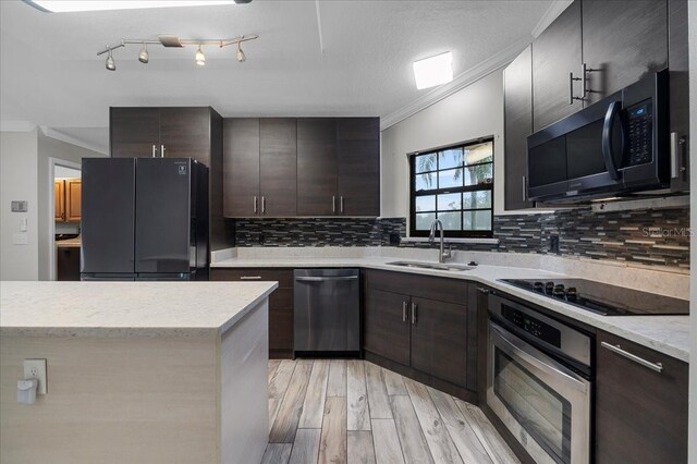 kitchen featuring ornamental molding, black appliances, rail lighting, and decorative backsplash