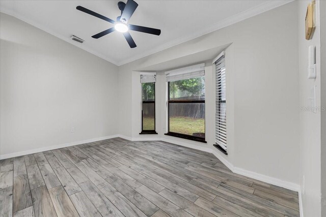 spare room featuring ornamental molding, wood-type flooring, and ceiling fan