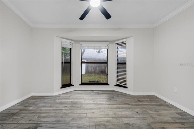 unfurnished room with ceiling fan, hardwood / wood-style flooring, and ornamental molding