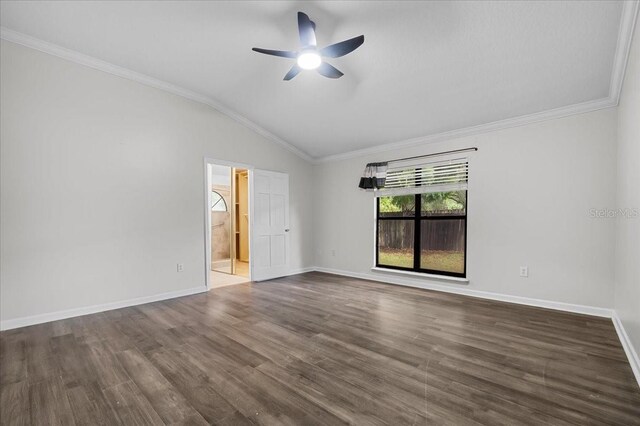 empty room featuring crown molding, ceiling fan, wood-type flooring, and vaulted ceiling