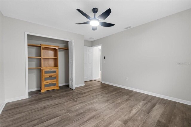 unfurnished bedroom with a closet, ceiling fan, and hardwood / wood-style floors