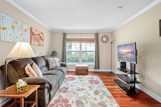 living room with hardwood / wood-style flooring, a textured ceiling, and ornamental molding