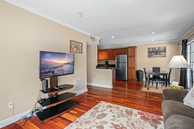 living room featuring dark hardwood / wood-style floors and ornamental molding