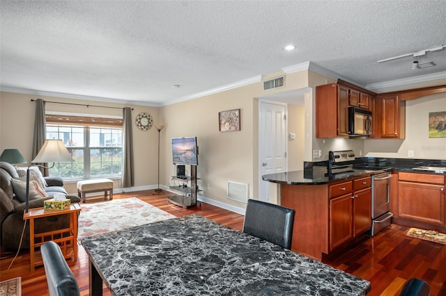 kitchen featuring electric range, dark hardwood / wood-style flooring, track lighting, a textured ceiling, and crown molding