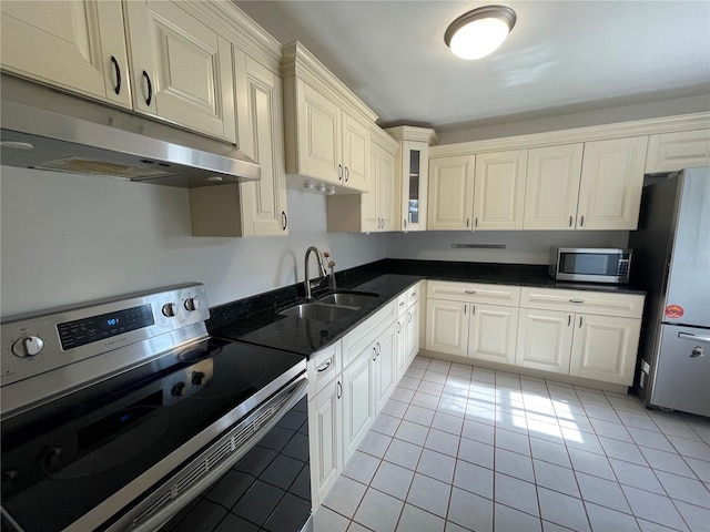 kitchen featuring sink, stainless steel appliances, and light tile patterned floors