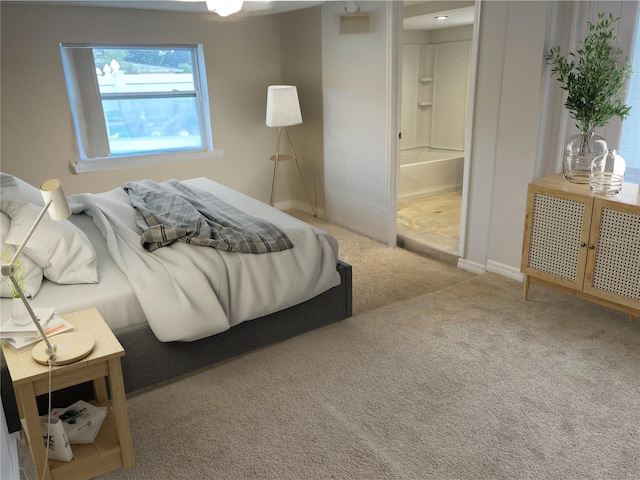 carpeted bedroom featuring ensuite bath