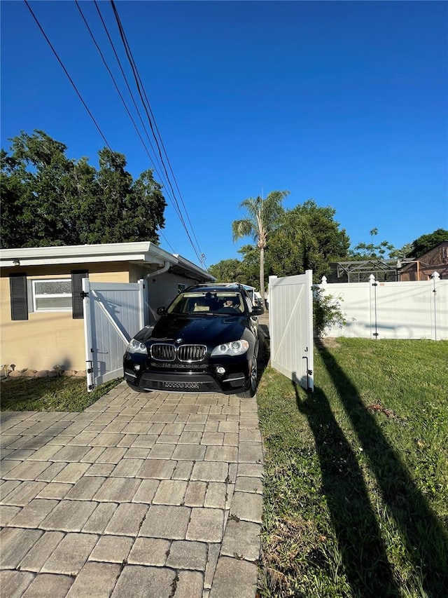 view of parking / parking lot featuring a yard