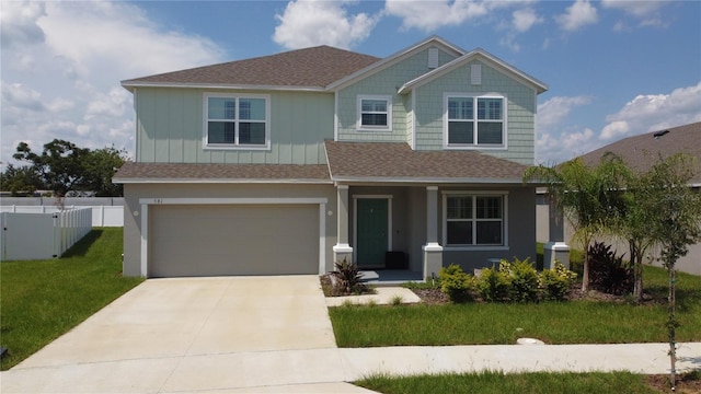 craftsman house featuring a front yard and a garage