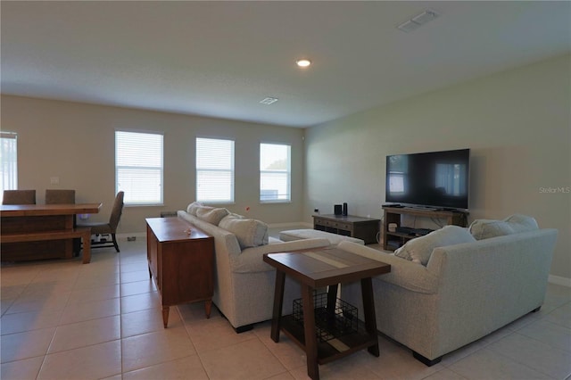 living area with light tile patterned flooring, visible vents, recessed lighting, and baseboards