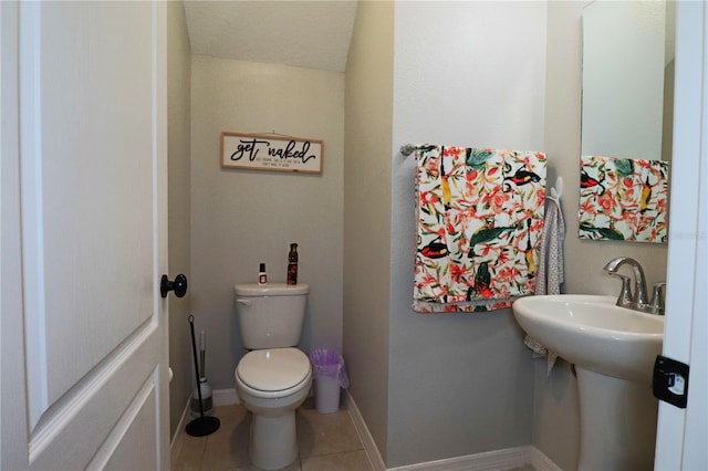 bathroom with vaulted ceiling, toilet, and tile patterned flooring