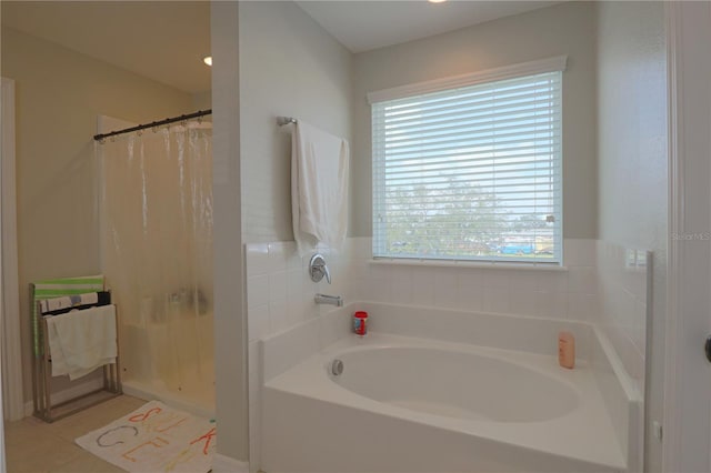 bathroom with tile patterned flooring and a washtub