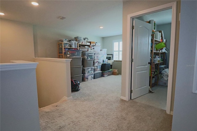 hallway featuring recessed lighting, carpet floors, and an upstairs landing