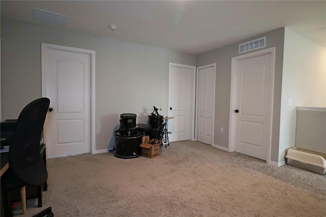 home office featuring carpet flooring, baseboards, and visible vents