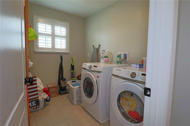 washroom featuring independent washer and dryer and light tile patterned flooring