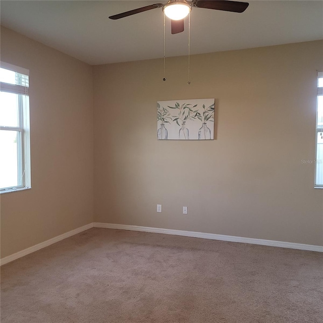 empty room featuring carpet and ceiling fan