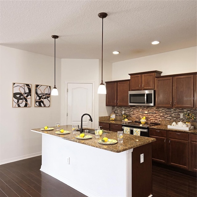 2652 Carrickton Cir, Orlando, FL 32824 - kitchen featuring stainless steel appliances, a sink, tasteful backsplash, dark wood-style floors, and dark stone countertops