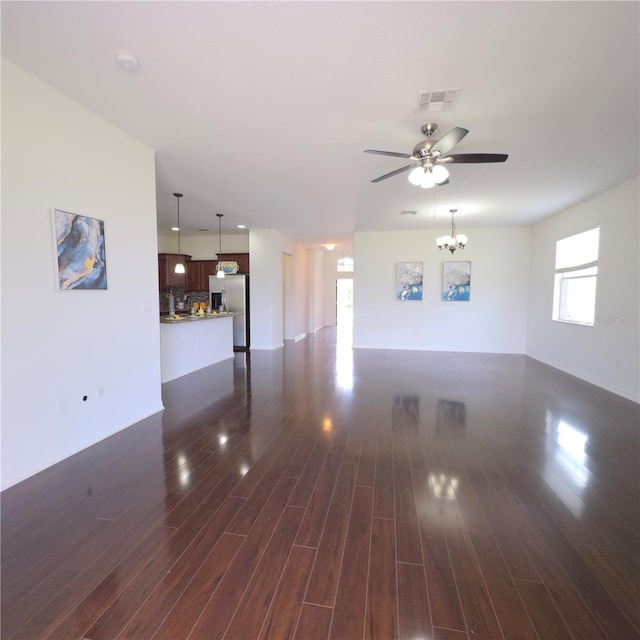 2652 Carrickton Cir, Orlando, FL 32824 - unfurnished living room with ceiling fan, dark wood finished floors, and a chandelier