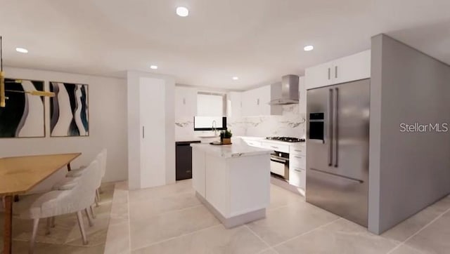 kitchen with wall chimney range hood, wall oven, a kitchen island, stainless steel built in fridge, and light tile patterned floors