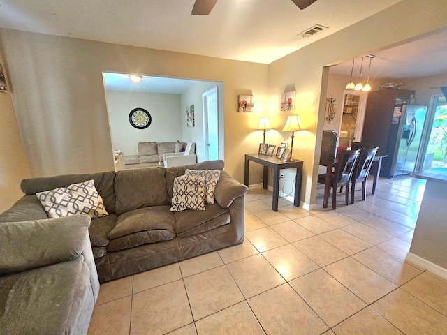 living room featuring light tile patterned flooring and ceiling fan