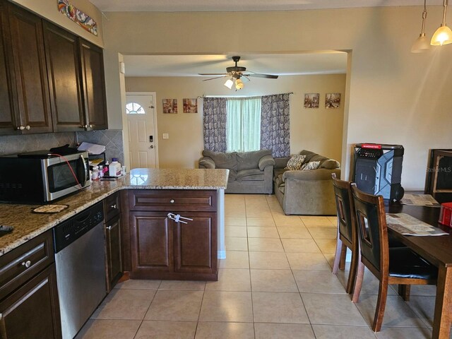 kitchen featuring light tile patterned flooring, dark brown cabinets, ceiling fan, and stainless steel appliances