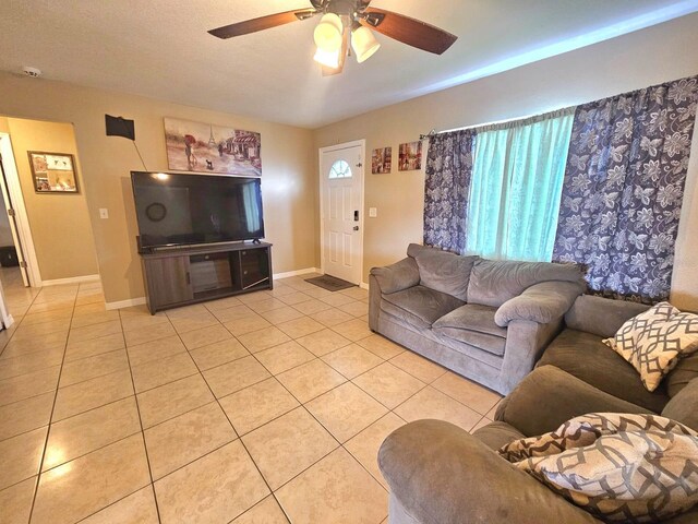 living room with light tile patterned flooring and ceiling fan