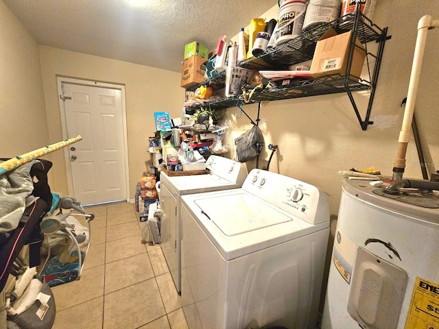 washroom featuring a textured ceiling, separate washer and dryer, light tile patterned floors, and electric water heater