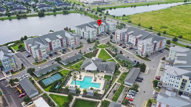 bird's eye view with a water view and a residential view