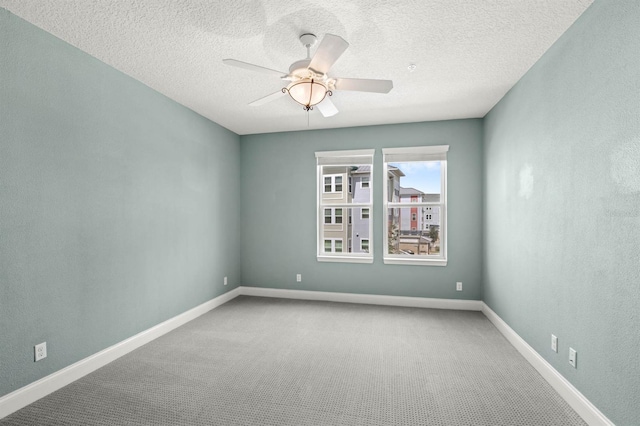 empty room with carpet, a textured ceiling, and ceiling fan