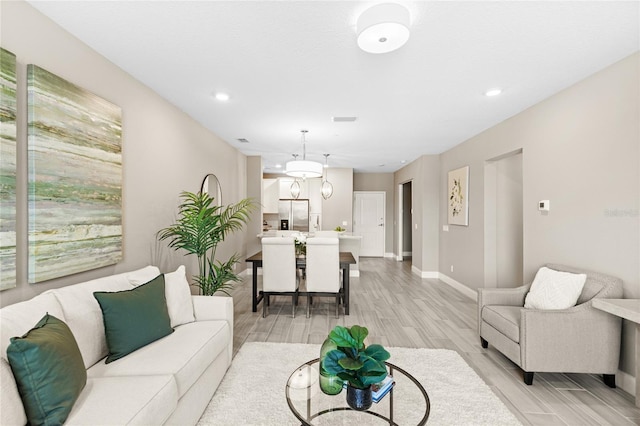 7573 Laureate Blvd Unit 1301, Orlando, FL 32827 - living room featuring light wood-type flooring, baseboards, and recessed lighting
