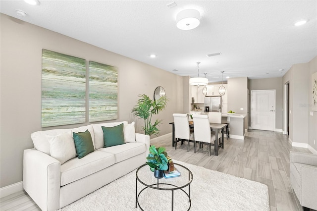 7573 Laureate Blvd Unit 1301, Orlando, FL 32827 - living room with baseboards, light wood-style flooring, and recessed lighting