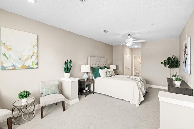 7573 Laureate Blvd Unit 1301, Orlando, FL 32827 - bedroom featuring light carpet, baseboards, ensuite bath, a ceiling fan, and a textured ceiling