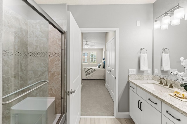 7573 Laureate Blvd Unit 1301, Orlando, FL 32827 - bathroom featuring a stall shower, vanity, ensuite bathroom, a ceiling fan, and baseboards
