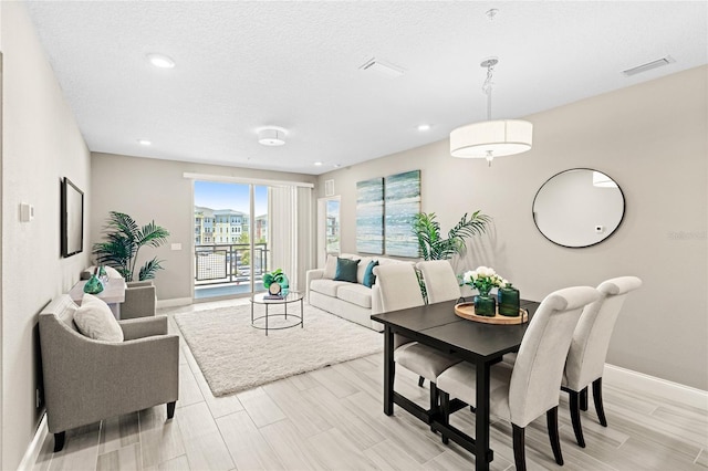 7573 Laureate Blvd Unit 1301, Orlando, FL 32827 - living area featuring baseboards, recessed lighting, light wood finished floors, and a textured ceiling