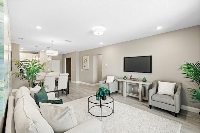 7573 Laureate Blvd Unit 1301, Orlando, FL 32827 - living area with baseboards, light wood-style flooring, and recessed lighting