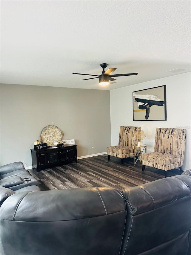 living room with ceiling fan and dark hardwood / wood-style flooring