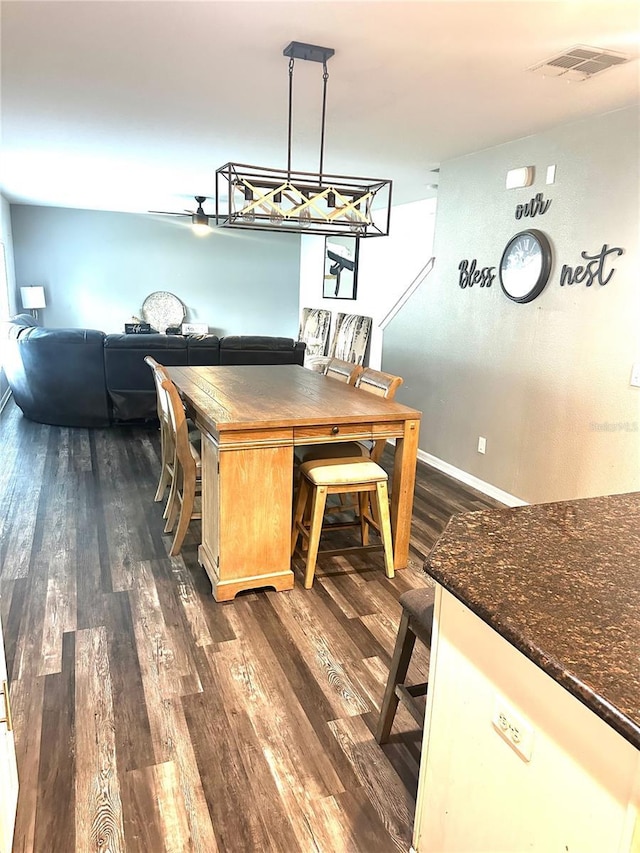 dining area with dark hardwood / wood-style floors