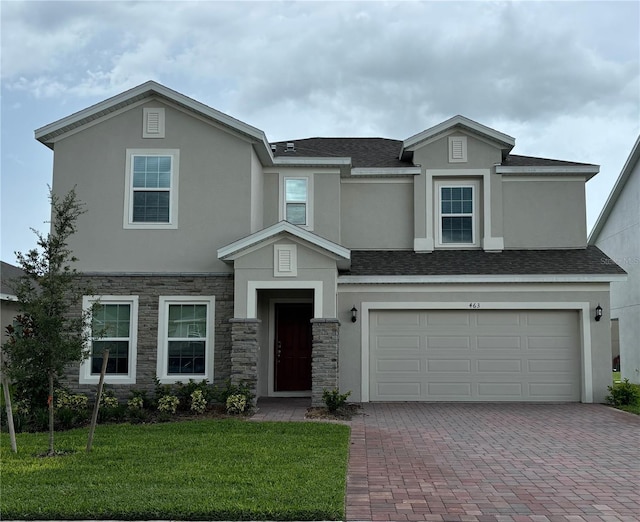 view of front of property with a front lawn and a garage