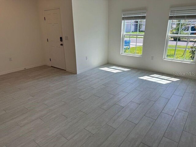 unfurnished room with light wood finished floors