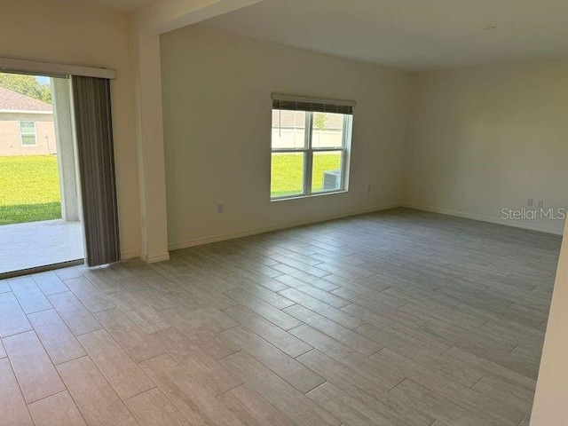 unfurnished room featuring light hardwood / wood-style floors and a healthy amount of sunlight