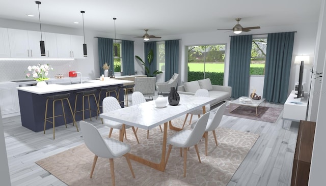 dining space with ceiling fan, light hardwood / wood-style flooring, and a healthy amount of sunlight