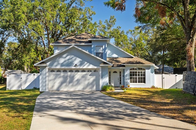 view of front of property with a front yard and a garage