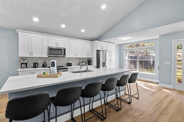 kitchen featuring white cabinetry, an island with sink, and appliances with stainless steel finishes