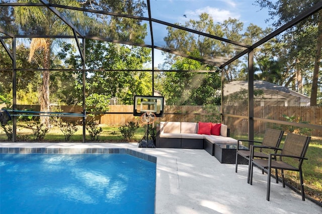 view of swimming pool featuring a patio area and a lanai